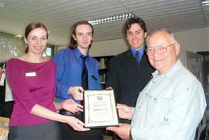 Gippsland Portal Team Members Emma Lewis, Adam George and Joel Edwards accept the certificate as presented by Morwell Football Club Snr Vice President Jack Huxtable
