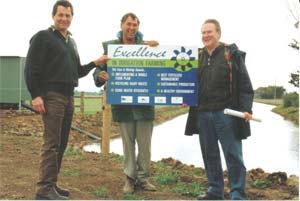 NRE Officers Les Kewming and Alistair Christie present John Barnett with his 'Excellence in Irrigation' sign